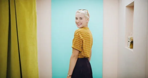 Portrait of dancing female customer showing off a fashionable outfit in interior Stock Footage 199455459