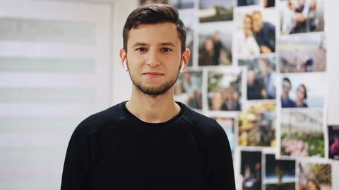 Portrait of dancing man while listening to music in wireless headphones Stock Footage 97387093