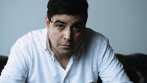 Portrait of Dark Haired Man Looking at Camera with a Serious Face Stock Footage 120425529