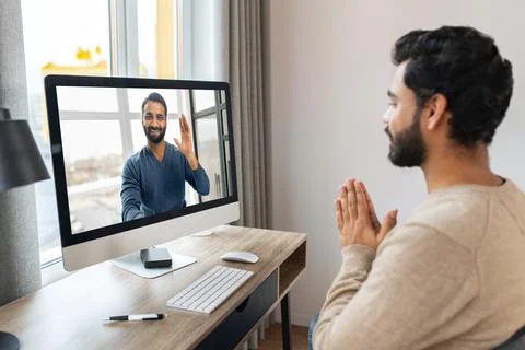 Portrait of dark-haired man using computer in home office. Brunette male Foto stock