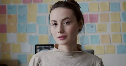 Portrait of dark-haired woman posing on camera while sitting at home office with Stock Footage 148564174
