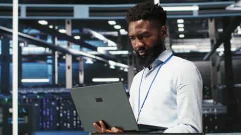 Portrait of data center engineer analyzing gear issues using node tree tool Stock Footage 307019143