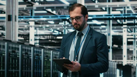 Portrait of data center engineer monitors system performance using AR simulation Stock Footage 329453461