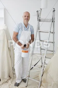 Portrait Of Decorator Painting Room Stock Photos