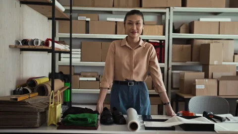 Portrait of Delivery Manager at Working Desk with Equipment for Parcels Packing 스톡 동영상 281716031