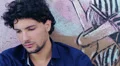 portrait depressed and sad boy sitting near a graffiti wall HD Footage