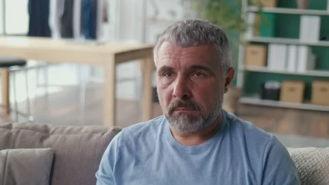 Portrait of a Depressed Elderly Man Sitting Alone on a Sofa. Psychological Stock Footage 170959675