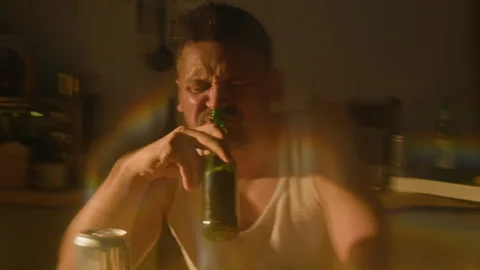 Portrait of Depressed Man Drinking Beer with Alcohol Addiction Stock Footage 344872594