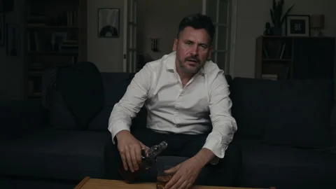 Portrait of Depressed Middle Aged Man Drinking Alcohol Alone at Night Stock Footage 344861310