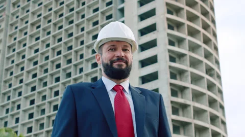 Portrait of a design engineer in a white protective helmet in a business suit Stock Footage 167883416
