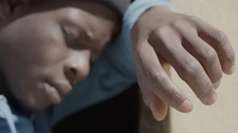 Portrait of desperate black man with closed eyes leaning against a wall Stock Footage 224286904