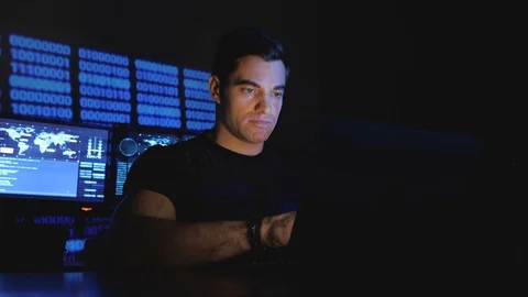 Portrait of developer hacker programmer working on computer in a data center Stock Footage 102900306