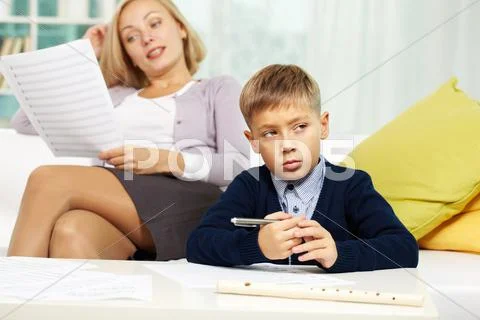 Portrait of diligent pupil with musical notes on paper near by and his tutor on Stock Photos