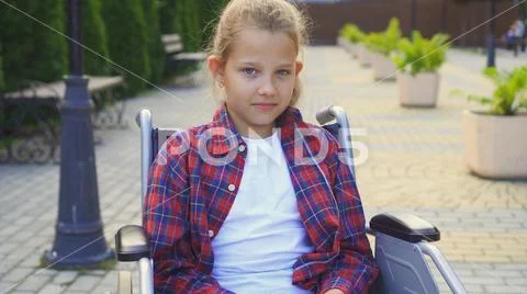Portrait of a disabled child in a chair Stock Photos