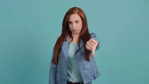 Portrait of a discontented young girl making a thumbs down gesture. Stock Footage 139691253