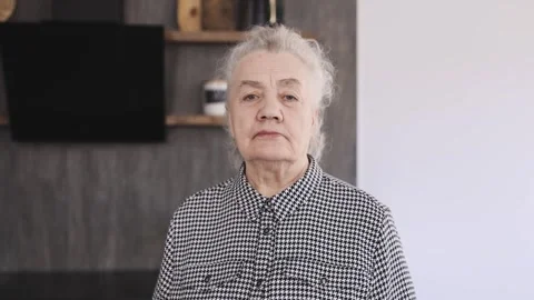 Portrait of a distraught elderly pensioner looking at the camera. Camera Stock Footage 246029440