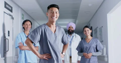 Portrait of diverse doctors and nurses smiling in corridor at hospital, in slow Stock Footage 344643782