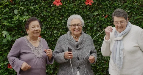 Portrait of diverse elderly women dancing happy enjoying celebrating retirement Stock Footage