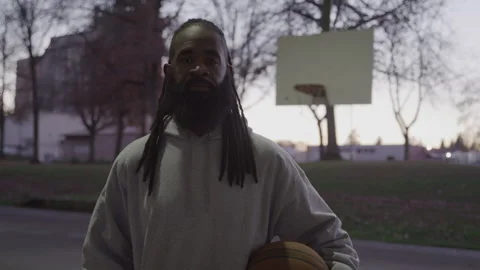 Portrait of Diverse Man with Dreadlocks and Beard Holding Basketball on Downtown Stock-Footage 270400458