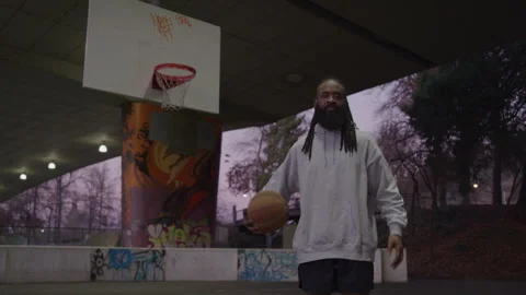 Portrait of Diverse Man with Dreadlocks and Beard Holding Basketball on Downtown Stock-Footage 270400470
