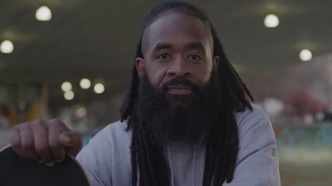 Portrait of Diverse Man with Dreadlocks Holding Skateboard at Downtown Skate Stock Footage 270399976