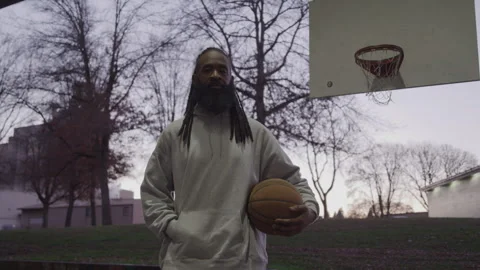 Portrait of Diverse Man with Dreadlocks Holding Basketball on Downtown Court at Stock Footage