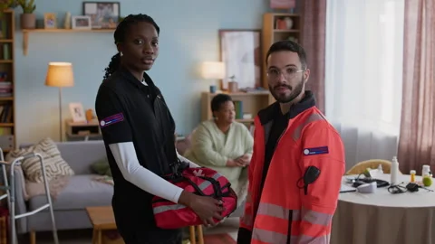 Portrait of Diverse Paramedics Posing with Senior Patient in Background in Flat Video stock 318901432