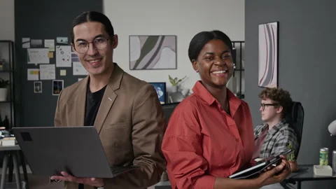 Portrait of Diverse Programmers Smiling with Laptop and Tablet in Office Stock-Footage 336711888