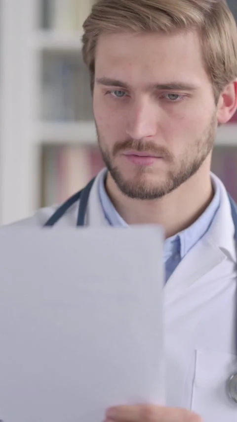 Portrait of Doctor Reading Documents in Office, Vertical Video Stock Footage 339577534