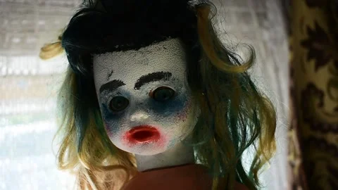 Portrait of a doll with makeup on a window background Stock Footage 148256410