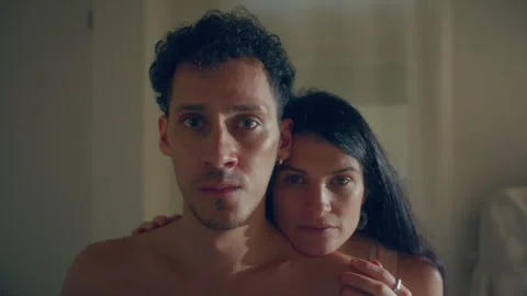 Portrait of Dramatic Young Couple Looking into Camera in Bedroom Stock Footage 346511942