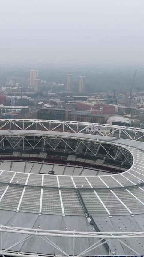 Portrait Drone Reverse over West Ham Stadium, Stratford, London, misty Video stock 312094064