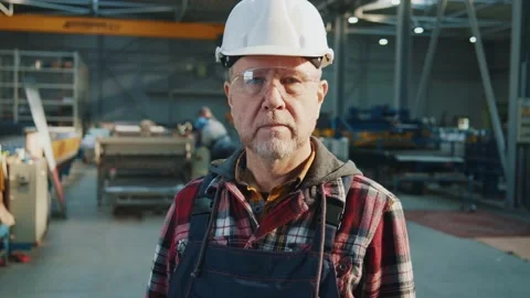 Portrait of elder man engineer worker with helmet and goggles look at camera in Stock Footage 174469887