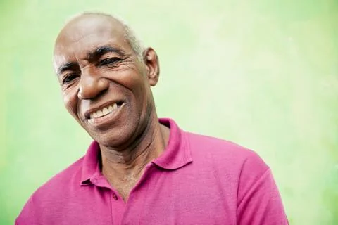 Portrait of elderly black man looking and smiling at camera Stock Photos
