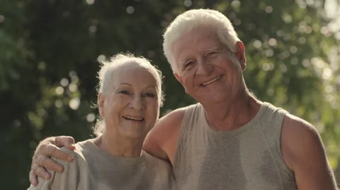 Portrait of elderly couple after fitness in park Stock Footage