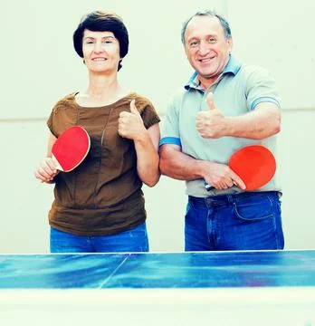 Portrait of elderly couple with rackets for table tennis Stock Photos