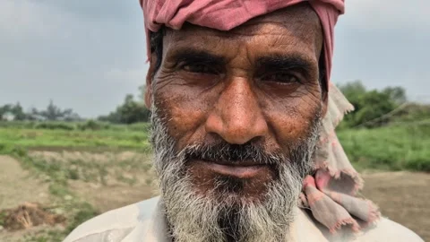 Portrait Of Elderly Farmer With Thoughtful Expression In Bangladesh Vidéo 338437588