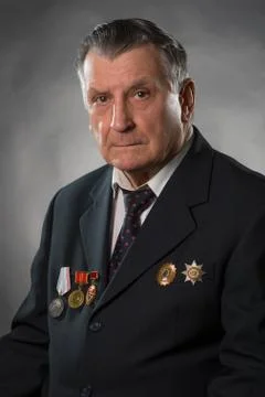 Portrait of an elderly gray haired man. On his chest medals of the Soviet per Stock Photos
