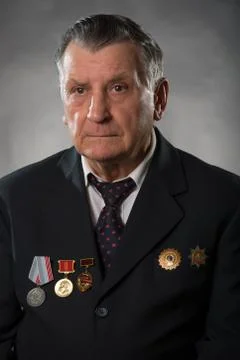 Portrait of an elderly gray haired man. On his chest medals of the Soviet per Stock Photos