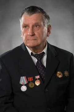 Portrait of an elderly gray haired man. On his chest medals of the Soviet per Stock Photos