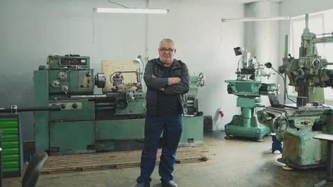 Portrait of an elderly locksmith turner with hands crossed on his chest in a Stock Footage 284545757