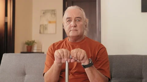 Portrait of Elderly Man with Cane on Sofa at Home Stock Footage 239352856
