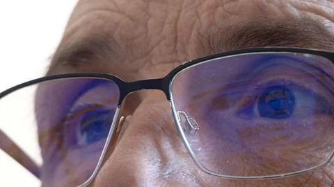 Portrait of an elderly man in glasses looking at a computer screen.  Stock Footage 127689542