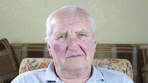 Portrait of an elderly man. Looking at the camera and winks. Stock-Footage 73583853