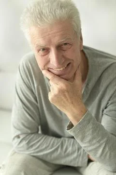 Portrait of an elderly man posing at home Stock Photos