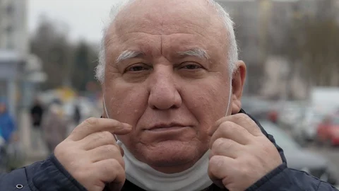 Portrait Elderly Man Puts Protective Medical Mask On His Face From Coronavirus Stock Footage 127585975
