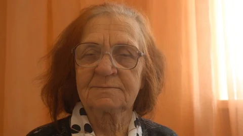 Portrait of a elderly woman looking at the camera Stock Footage 85031803