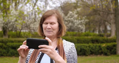 Portrait of elderly  woman using black smartphone Stock Footage 127821111