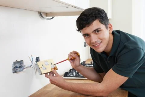Portrait Of Electrician Installing Socket In New House 스톡 사진