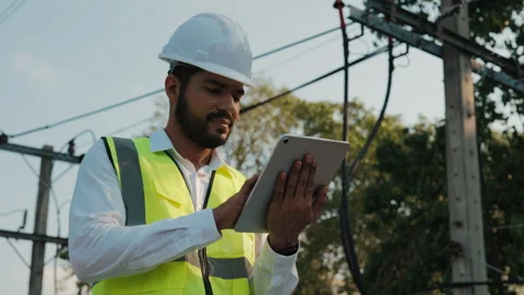 Portrait of electrician using tablet to set power transmission lines voltage Stock Footage 305762606